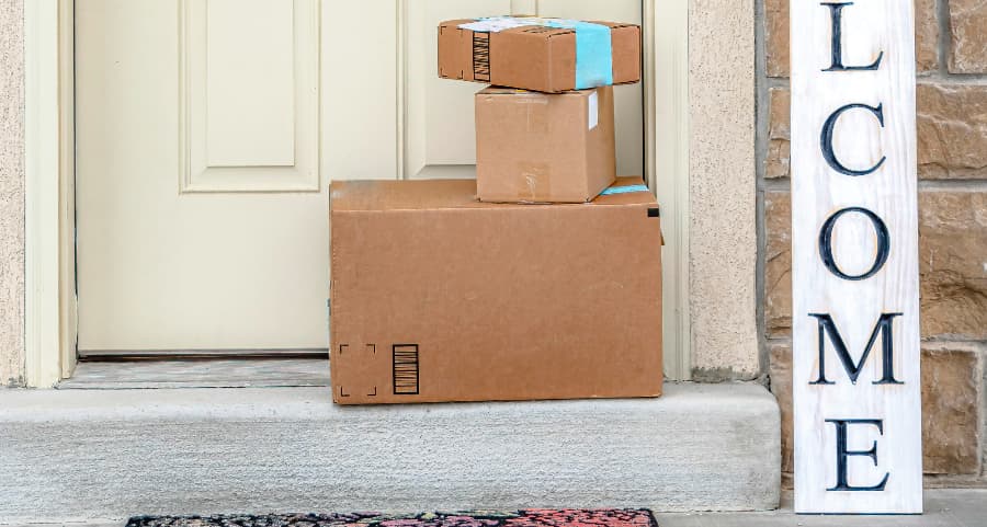 Deliveries on the front porch of a house with a welcome sign in Hammond